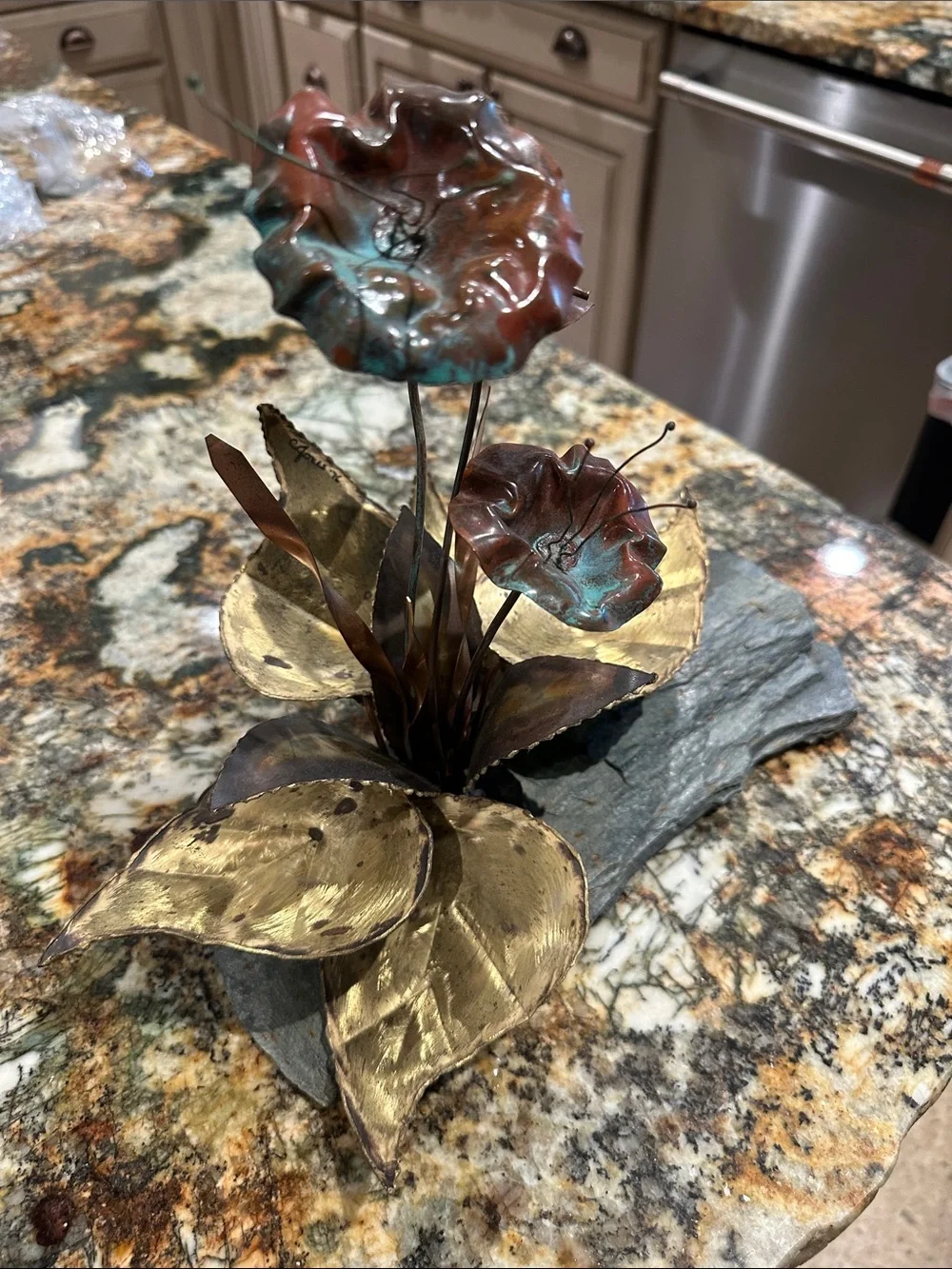 These are vintage Brutalist mixed metal floral sculptures mounted on slate bases
